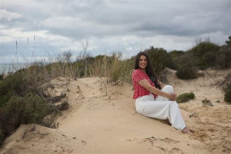 Junge Sch Ne Brunette Frau In Rotem Hemd Und Wei E Hosen L Cheln Und Gl Cklich Sitzen Auf Dem