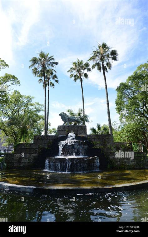 A Water Fountain With A Bronze Sculputre Of A Lion In Lyons Park In