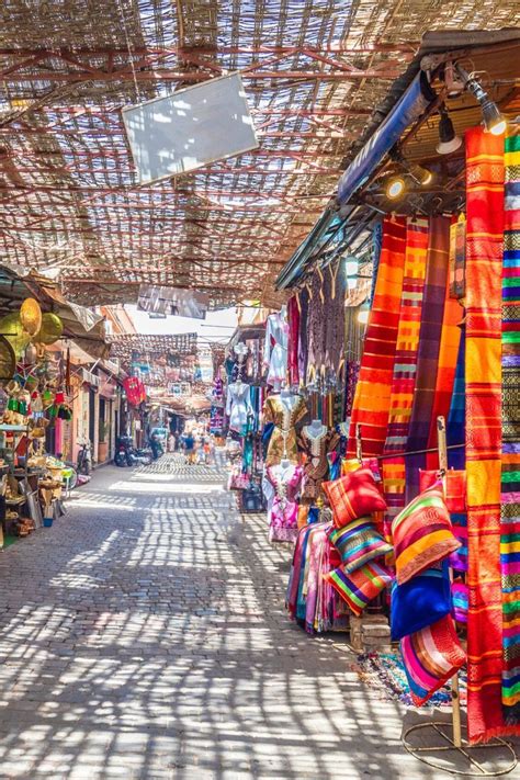 Colorful souk marketplace in Marrakech, Morocco with vibrant textiles and spices
