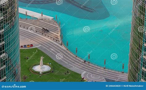 Park With Green Lawn Near Fountains Aerial Timelapse Towers Around