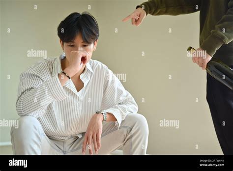 Desperate Gay Man Boring With Drunk Aggressive Boyfriend LGBTQ Relationship Concept Stock Photo