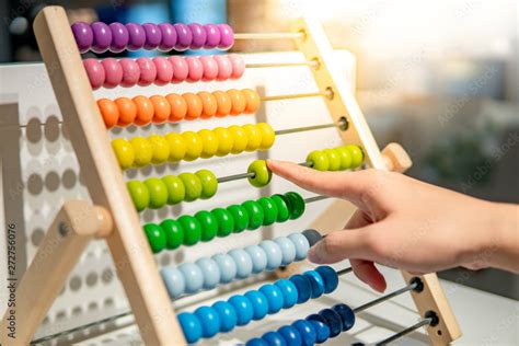 Male Hand Calculating With Beads On Wooden Rainbow Abacus For Number