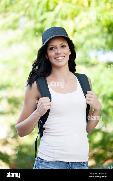 Beautiful Brunette Woman With Cap And Backpack Hiking Stock Photo Alamy