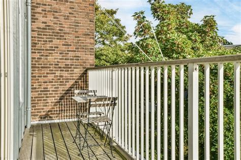 Premium Photo | A balcony with a table and two chairs on it