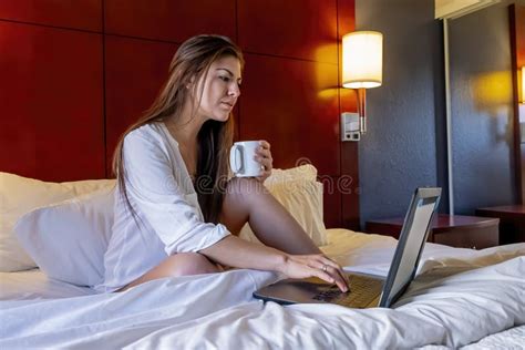 Gorgeous Hispanic Model Works On Her Computer As She Poses In Lingerie In A Bedroom Environment