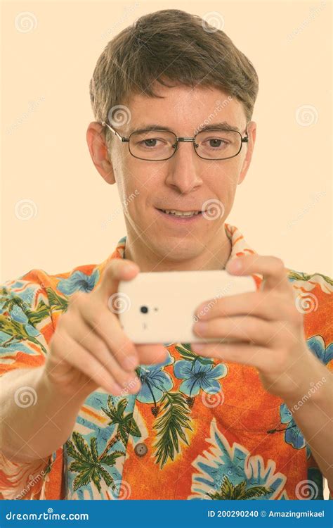 Face Of Happy Man Smiling While Taking Picture With Mobile Phone Stock