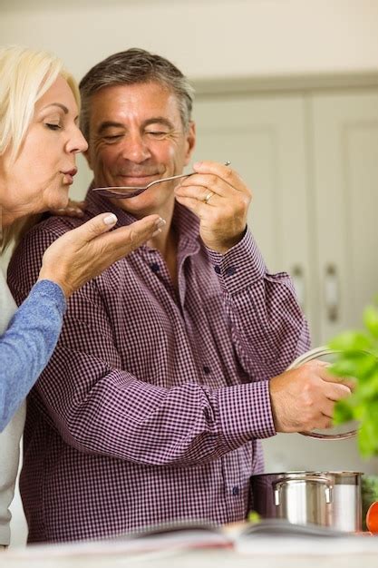 Premium Photo Mature Couple Preparing Meal Together