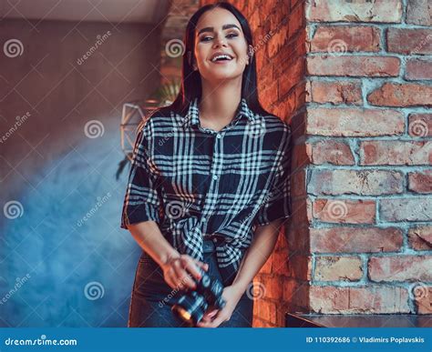 Portrait Of An Attractive Brunette Dressed In Flannel Shirt Stock Photo