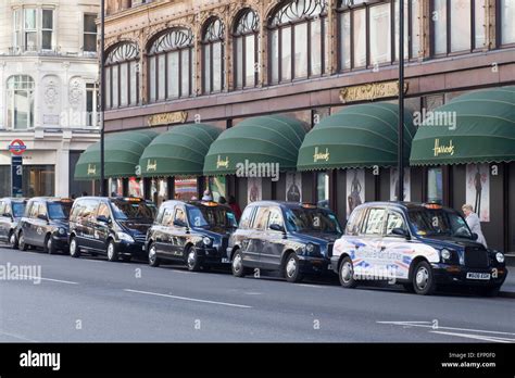 Londons Famous Black Cabs Parked Outside Harrods London Stock Photo
