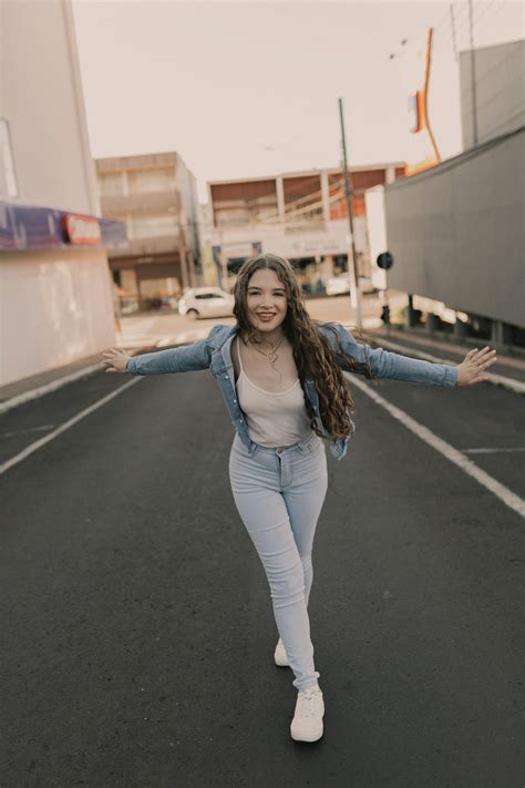 woman walking   street   arms outstretched photo