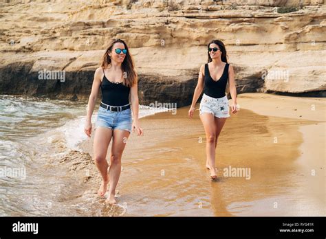 beautiful young girls walking   beach stock photo alamy