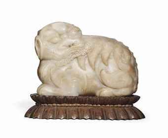 A Large Pale Celadon And Russet Jade Buddhist Lion Ming Dynasty