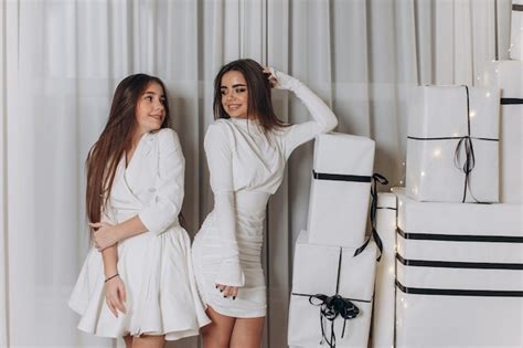 Premium Photo Two Beautiful Models A Redhead And A Brunette In New Year S Dresses Having Fun