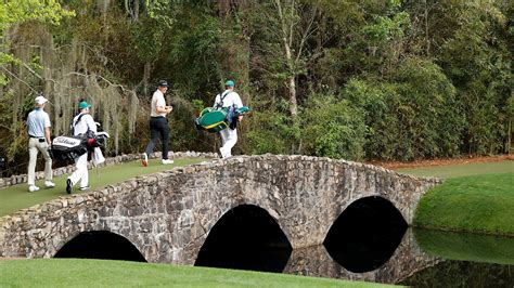 Will Zalatoris And Justin Rose Of England Walk Over The Nelson Bridge