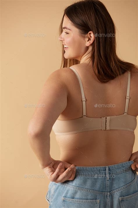 Plus Size Woman Back View Of Happy Full Figured Woman Posing In Beige Lingerie Stock Photo By