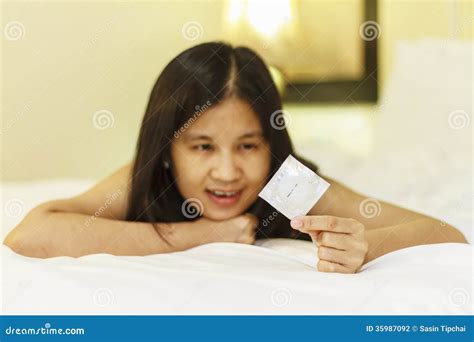 Asia Woman Hold Condom Lying Stock Photo - Image: 35987092