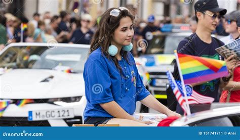 A Pretty Woman Sitting In A Car With Rainbow Flags Attending The Gay Pride Parade Also Known As