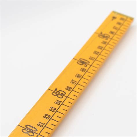 yellow meter stick wooden ruler