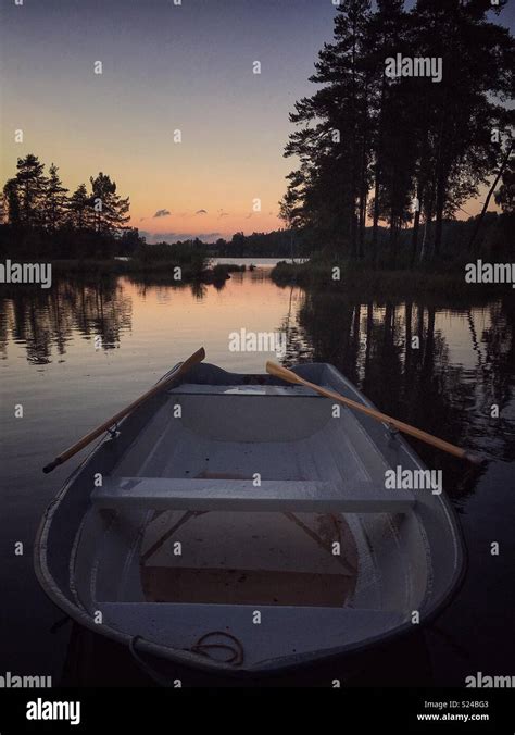 Rowing boat at sunset hi-res stock photography and images - Alamy