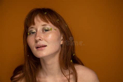Ginger Model With Naked Shoulders Holding Lilies And Looking At The Camera Stock Image Image