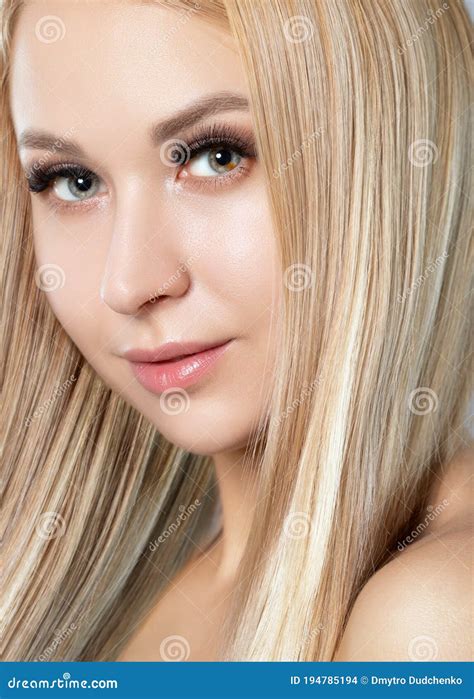 Portrait Of A Beautiful Smiling Blonde Woman With Naked Shoulders With Blue Eyes Plump Lips
