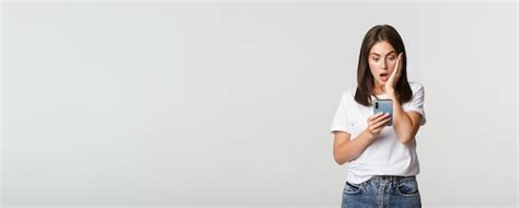 Premium Photo Shocked And Impressed Brunette Girl Looking Amazed At