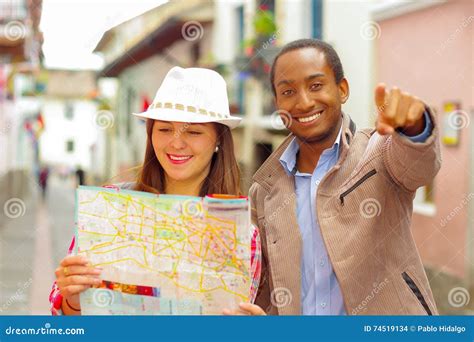 Interracial Happy Couple Wearing Casual Clothes In Urban Envrionment