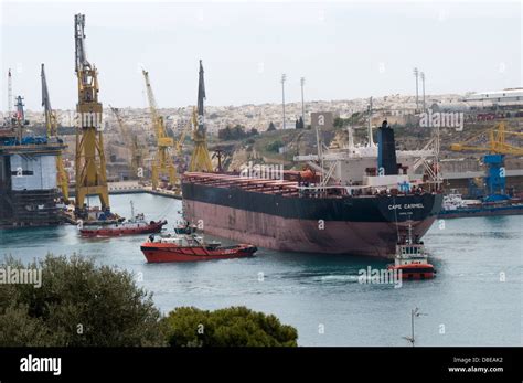 The Bulk Freighter Cape Carmel Is Carefully Guided Into The Malta Dry