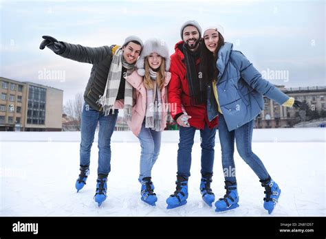 Happy Friends At Ice Skating Rink Outdoors Stock Photo Alamy