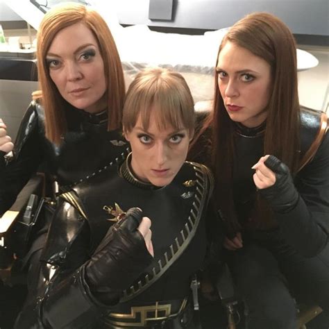 Three Women Dressed In Costumes Posing For The Camera