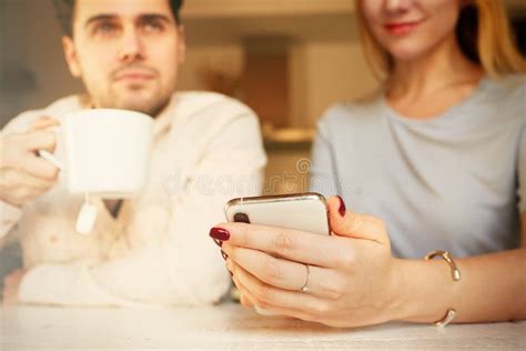 Attractive Hispanic Man And Blonde Woman Using Mobile Phones At Home Stock Image Image Of