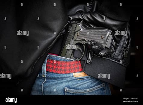 A Man Policeman Or Robber Gangster Concealing His Gun Behind His Back