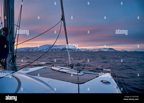 Sunrise Over Fjord With Snow Covered Mountains And Winter Landscape