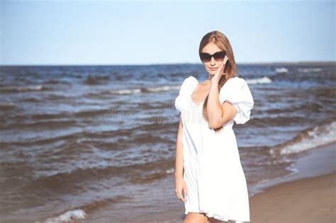 Happy Smiling Blonde Woman Is Posing On The Ocean Beach With Sunglasses Stock Photo Image Of