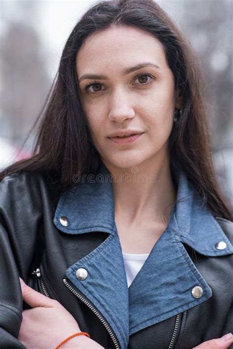 Portrait Of A Beautiful Brunette Girl Who Poses While Walking On The Street Stock Photo Image