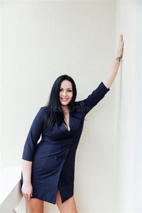 Fat Brunette Woman Standing Against A Light Wall Stock Photo Image Of Portrait Gift 275638878