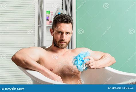 Man Wash Muscular Body With Foam Sponge Macho Attractive Nude Guy Man In Bathroom Stock Photo
