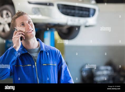 Mechanic Using Mobile Phone Stock Photo Alamy