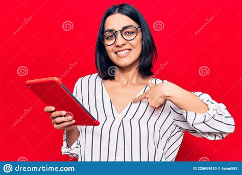 Jovem Linda Latina Segurando Touchpad Apontando Dedo Para Um Autosorrindo Feliz E Orgulhoso