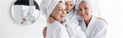 Positive Lesbian Mothers In Bathrobes Holding Stock Photo Image Of Elderly Moms