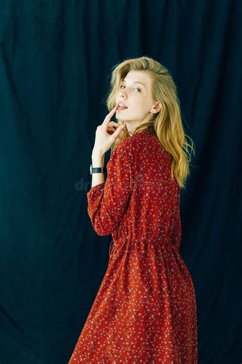 Beautiful Blonde Posing In A Red Dress A Girl With Long Curly Hair Stock Photo Image Of
