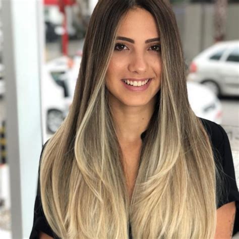 Soft Layered Cut With Straight Texture And Long Curtain Bangs On Blonde Balayage Highlighted