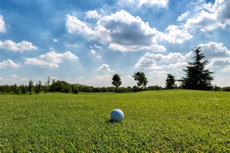 Premium Photo Small Golf Ball On Green Sunny Course