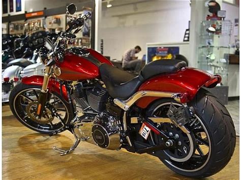 A Red And Black Motorcycle On Display In A Showroom With Other