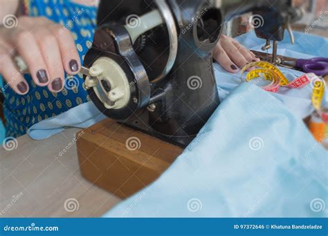 Woman Seamstress Sitting And Sews On Sewing Machine Dressmaker Work On