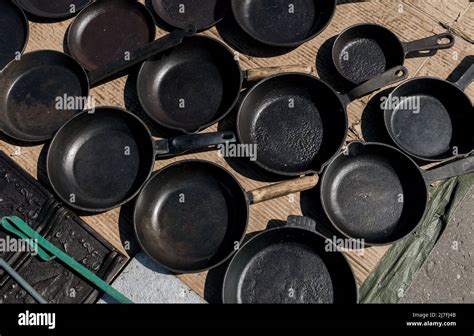 Many Vintage Empty Cast Iron Frying Pans On Floor Of Market Top View