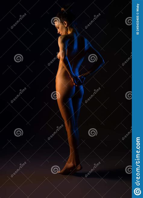 Nude Woman Gently Touching Wet Back In Dark Studio Stock Image Image Of Erotic Shadow 245433405