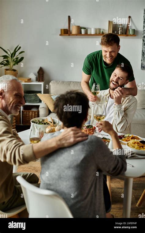 A Gay Couple Enjoys Dinner With Parents At Home Stock Photo Alamy