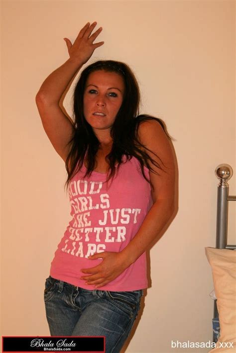 Sweet Brunette Chick Loves Posing Fully Clothed In The Bedroom Photos