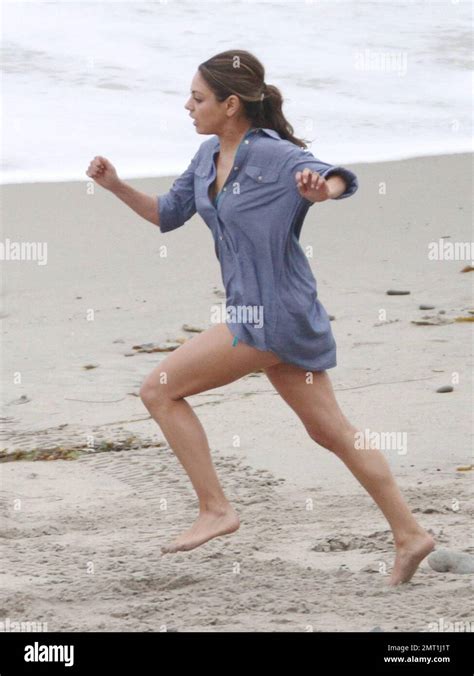 Mila Kunis Runs In Her Bikini And A Short Blue Shirt While Filming A Scene For Friends With